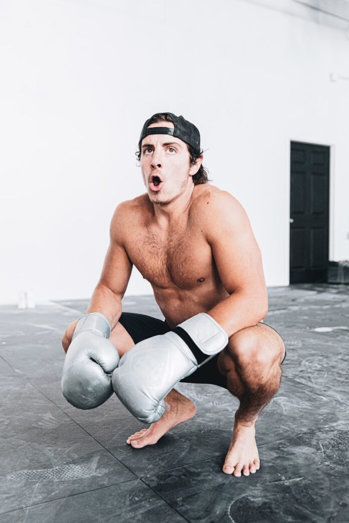 topless man wearing white shorts and white socks