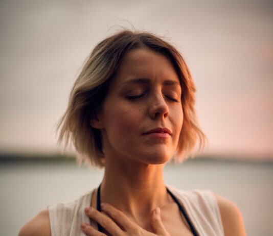 스트레스 관리로 삶의 질을 높이자 woman in white vest and black bikini with hand on chest