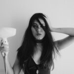 “두피부터 모발까지, 건강하게 지키는 생활 속 헤어 케어 트렌드” woman in black tank top holding her hair