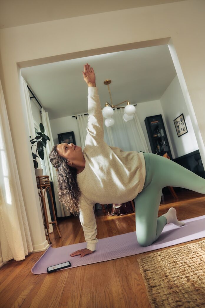 Photo by Microsoft Copilot A woman does a yoga pose on a mat.