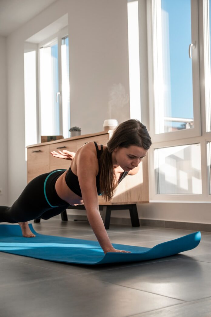 Photo by Stan Georgiev a woman doing a plank exercise on a yoga mat